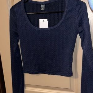 This is a navy blue knit crop top. It’s high quality and never been worn
